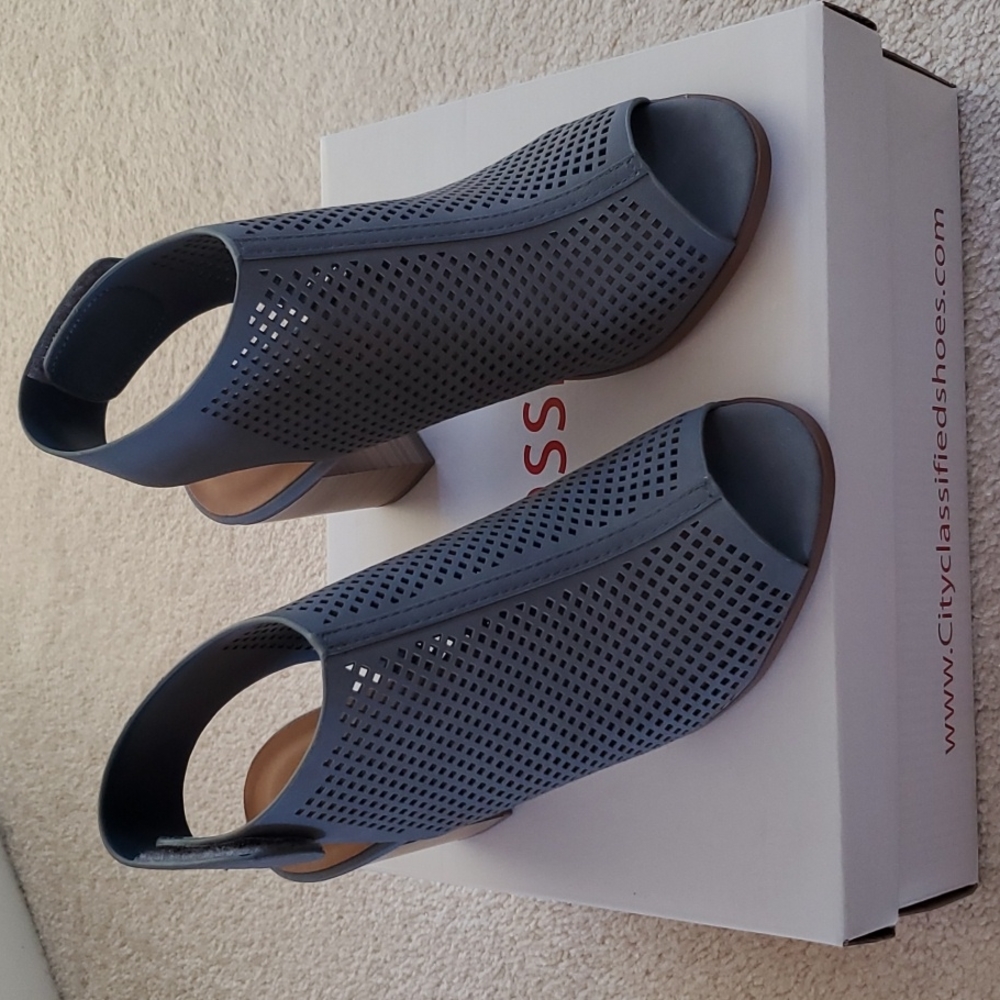 Brand new. Never worn. Size 6 light blue/grey peep toe sandal